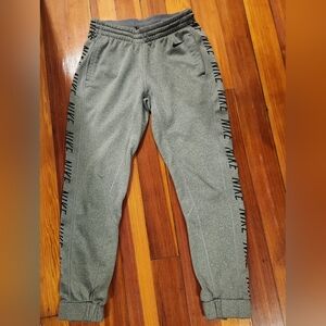 Women's tapered small grey Nike jogger with pockets and zippers